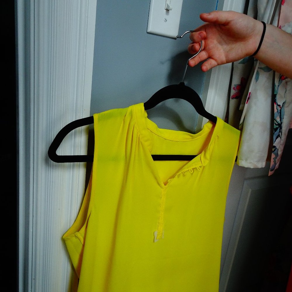 yellow sleeve less button up shirt